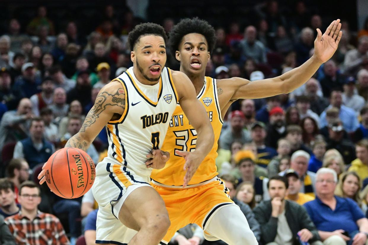 Toledo Rockets guard Ra'Heim Moss (0) drives to the basket against Kent State Golden Flashes forward Miryne Thomas (33) during the second half at Rocket Mortgage Field House March 11, 2023, in Cleveland, Ohio.