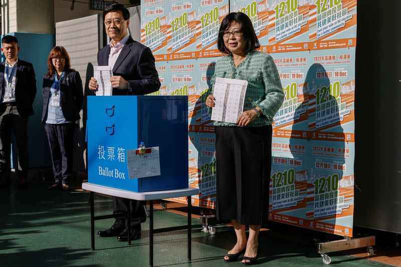 Hong Kong Chief Executive John Lee and his wife Janet Lee Lam Lai-sim vote at a polling station during the District Council election in Hong Kong