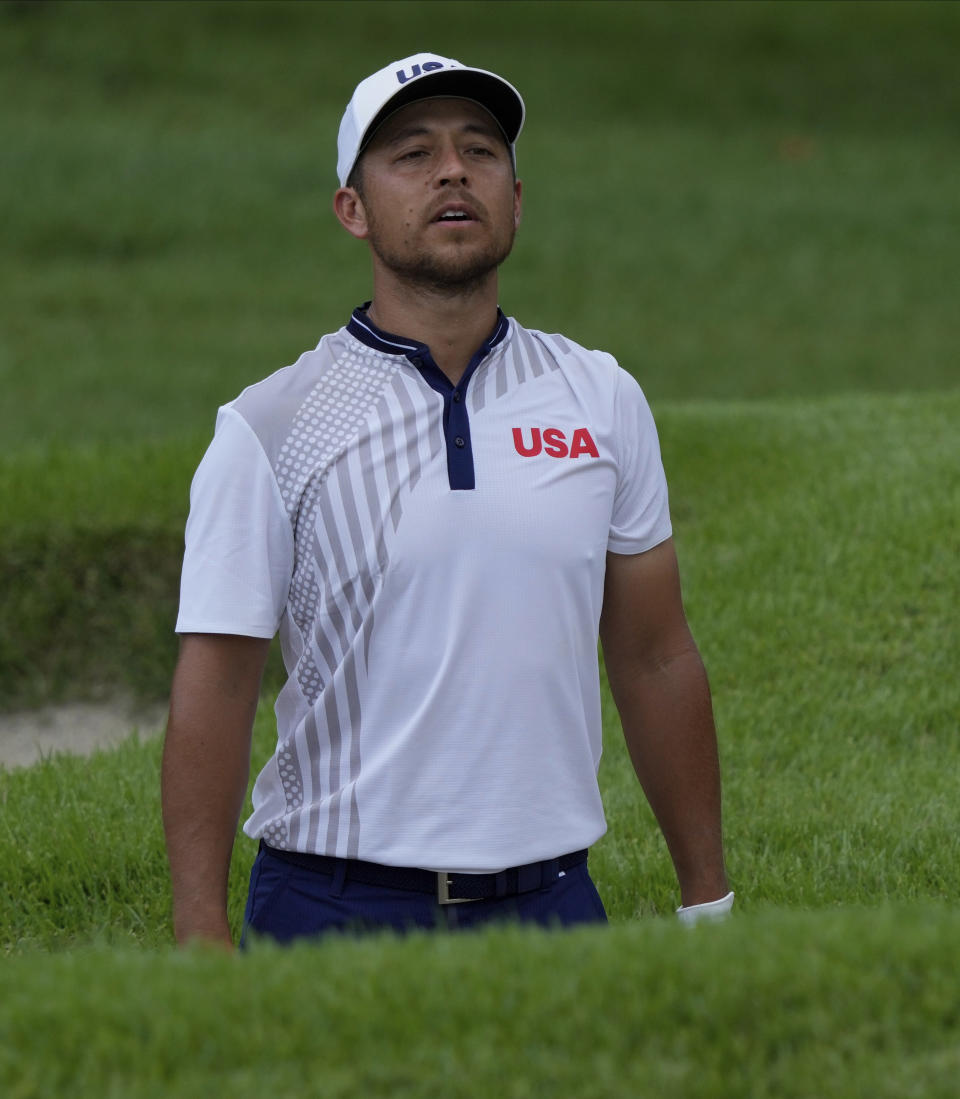 Xander Shauffele of United States studies his bunker shot on the first hole during the third round of the men's golf event at the 2020 Summer Olympics on Saturday, July 31, 2021, in Kawagoe, Japan. (AP Photo/Andy Wong)