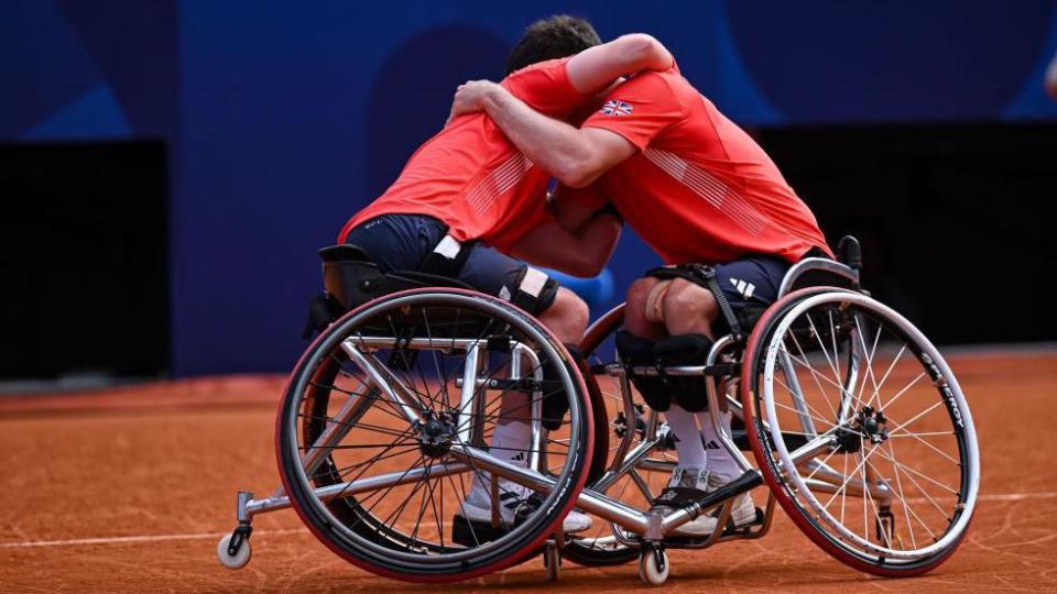 Alfie Hewett and Gordon Reid embrace with a big hug after winning the Paralympic wheelchair tennis men's doubles gold medal