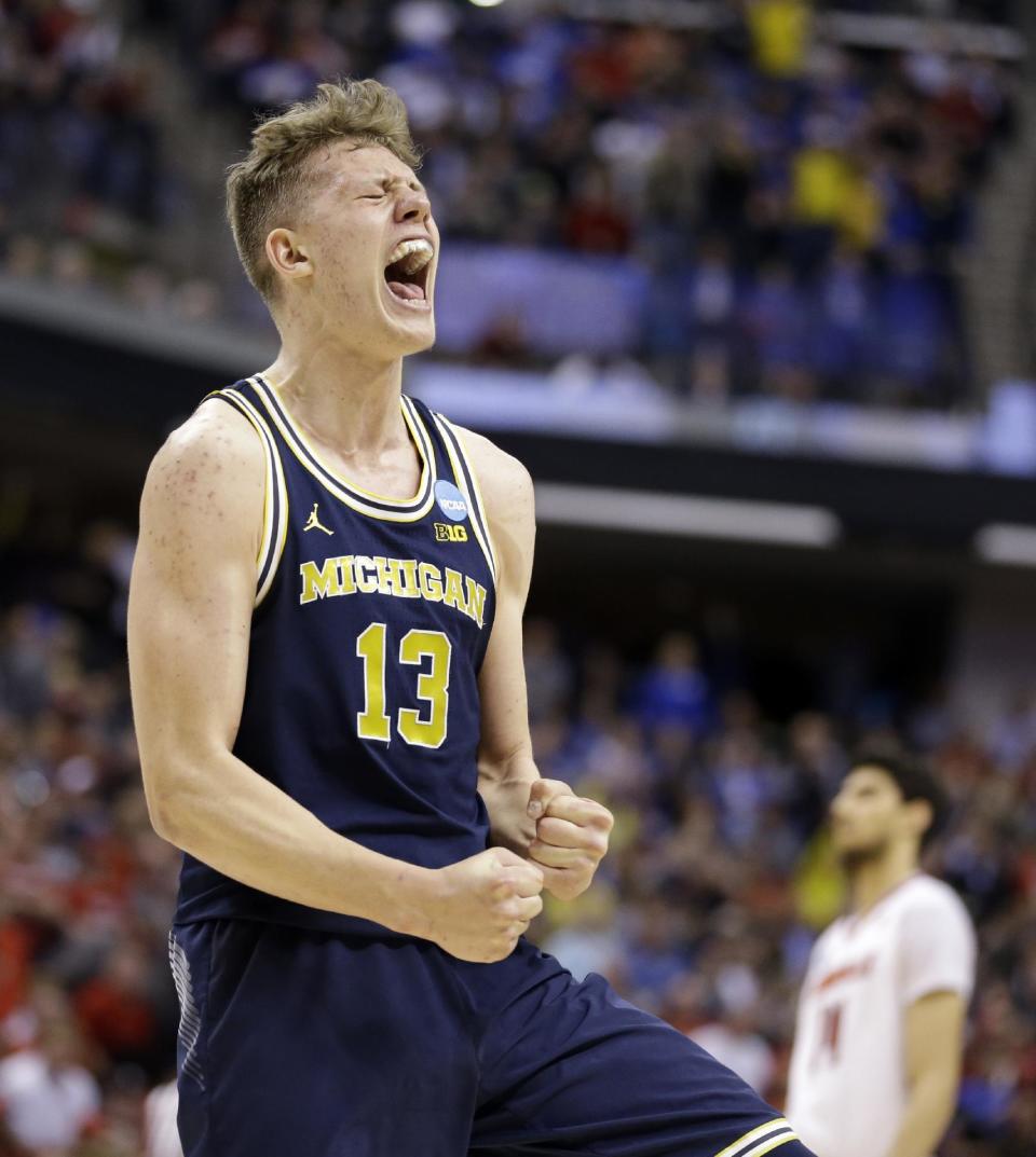 Michigan forward Moritz Wagner (13) celebrates a 73-69 win over Louisville in a second-round game in the men’s NCAA college basketball tournament in Indianapolis, Sunday, March 19, 2017. (AP Photo/Michael Conroy)