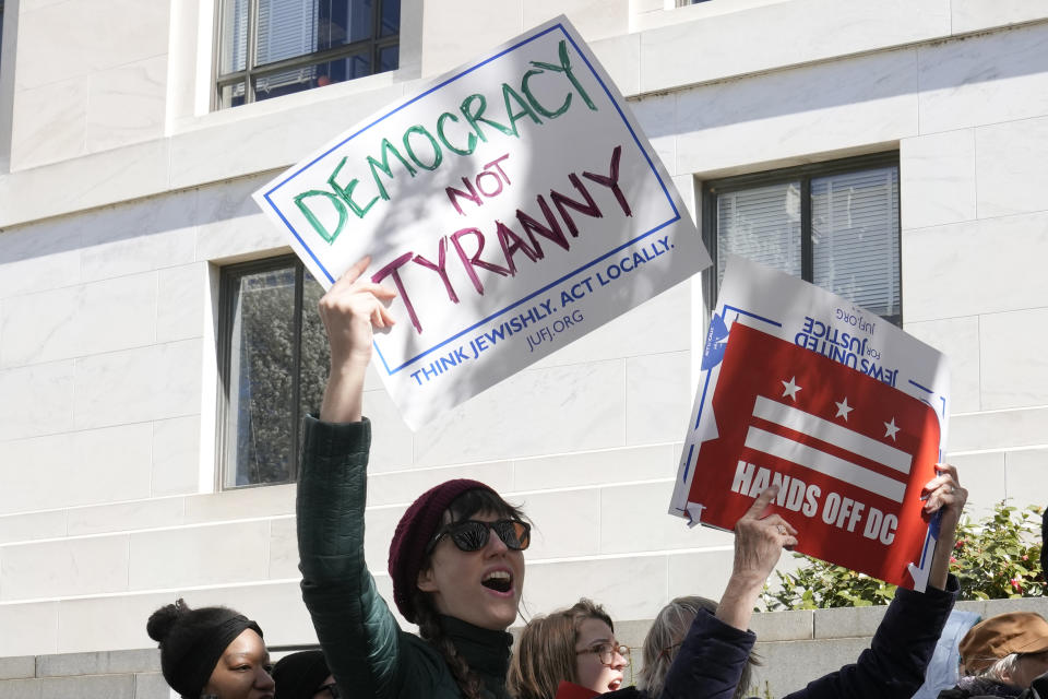 Demonstrators hold signs during a protest in front of the Dirksen Senate Office Building, Wednesday, March 8, 2023, on Capitol Hill in Washington. Protestors rallied against a Republican-sponsored resolution blocking new District of Columbia laws that would overhaul how the nation's capital prosecutes and punishes crime. (AP Photo/Mariam Zuhaib)