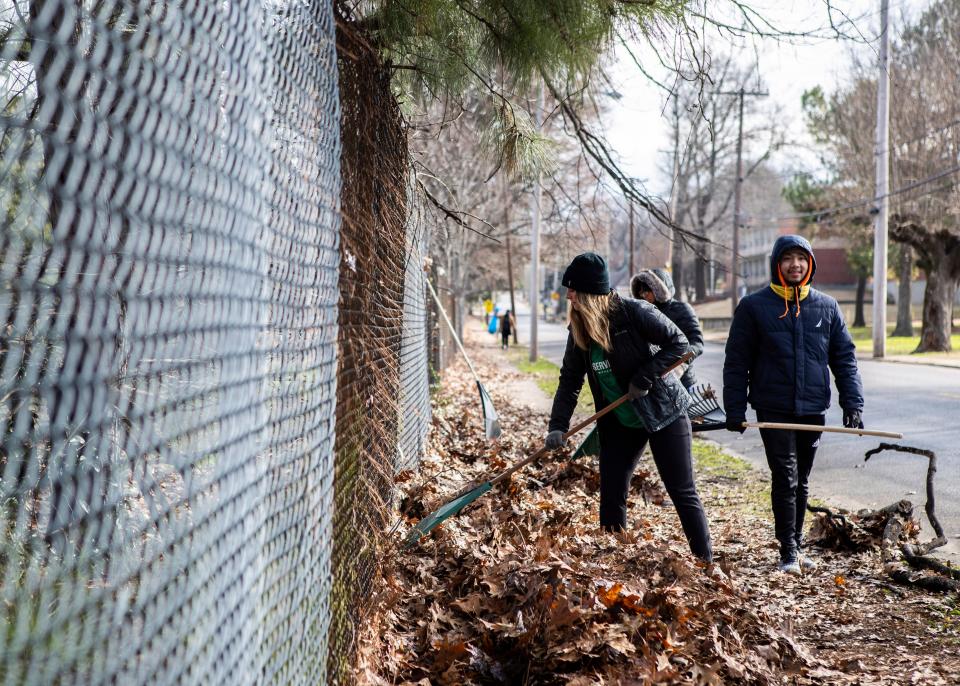 Elmwood Cemetery volunteers use rakes to help spruce up Walker Avenue and the surrounding area during MLK Days of Service in Memphis on Jan. 20, 2020.