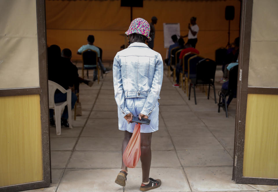 A worshipper arrives for a church service at the Cosmopolitan Affirming Community church, which serves a predominantly LGBTQ congregation, in Nairobi, Kenya, on Sunday, Oct. 17, 2021. Associate Pastor Caroline Omolo says some Kenyan religious leaders blame LGBTQ people for the coronavirus pandemic. “When we say we are still serving God, they don’t see something that’s possible,” she said. “They think it’s something unfamiliar and should be stopped.” (AP Photo/Brian Inganga)