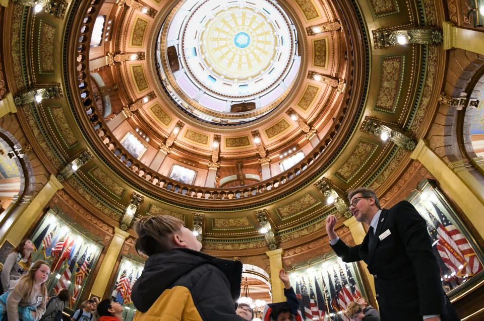 Michigan State Capitol Special Events Coordinator Jerry Benson points out details in the Capitol rotunda during a tour with Washington Street Elementary fourth-grade students from Otsego Friday, April 15, 2022.