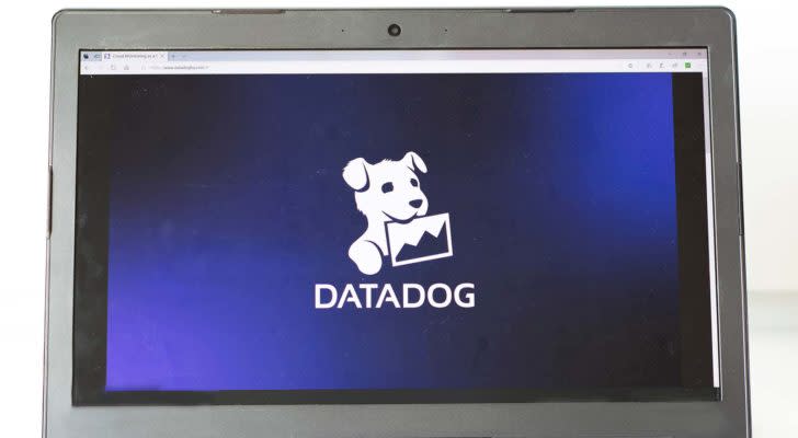 The Datadog (DDOG) logo displayed on a laptop screen.