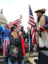 In this Wednesday, Jan. 6, 2021, photo provided to The Associated Press, Republican Women’s Federation of Michigan Vice President Londa Gatt stands with others outside the Capitol building in Washington. In mid-February, she said the FBI knocked on her door to ask where she was on the day of the Capitol attack. She says she climbed the scaffolding outside the Capitol building “to take a picture of the whole view.” And she said she gladly told the agents that she did nothing wrong, and left the scene as things turned violent. (AP Photo)