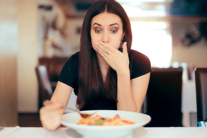 A woman eating food from a bowl