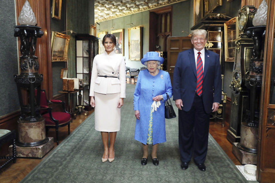 <p>Britain’s Queen Elizabeth II , center, poses for a photo with US President Donald Trump and his wife, Melania, in the Grand Corridor during their visit to Windsor Castle, Friday, July 13, 2018, in Windsor, England. (Photo: Steve Parsons/Pool Photo via AP) </p>