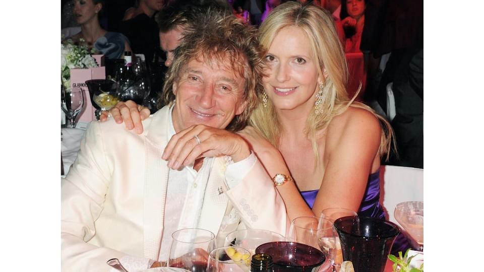 Rod Stewart and Penny Lancaster cuddling at the dinner table