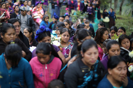 Mourners gather around the grave of Misael Paiz, 25, at his funeral in Aguacate, Huehuetenango, Guatemala, October 29, 2018. REUTERS/Lucy Nicholson