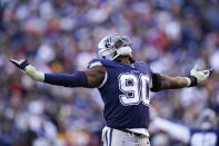 Dallas Cowboys defensive end Demarcus Lawrence (90) reacting after sacking Washington Football Team quarterback Taylor Heinicke (4) during the second half of an NFL football game, Sunday, Dec. 12, 2021, in Landover, Md. Dallas won 27-20. (AP Photo/Julio Cortez)