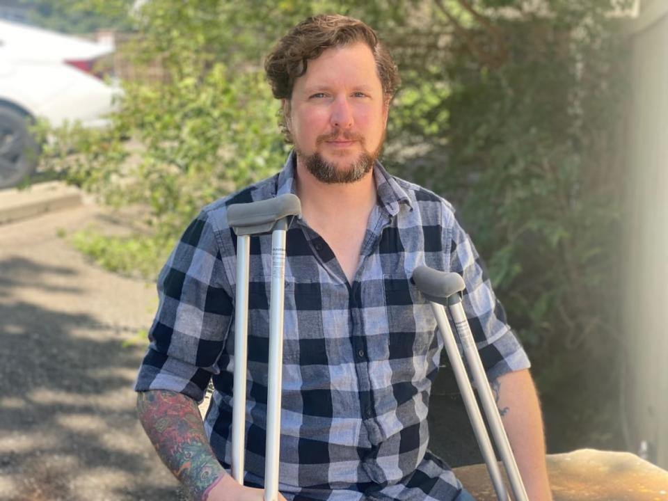 Matthew Pugsley was moving from Oshawa to Etobicoke when his car, which was parked outside his new building, was hit by a moving truck as it drove away. He says nobody will take responsibility for the thousands of dollars worth of damage. (Talia Ricci/CBC - image credit)