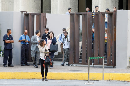 People evacuate an office building after an earthquake in Caracas, Venezuela August 21, 2018. REUTERS/Marco Bello