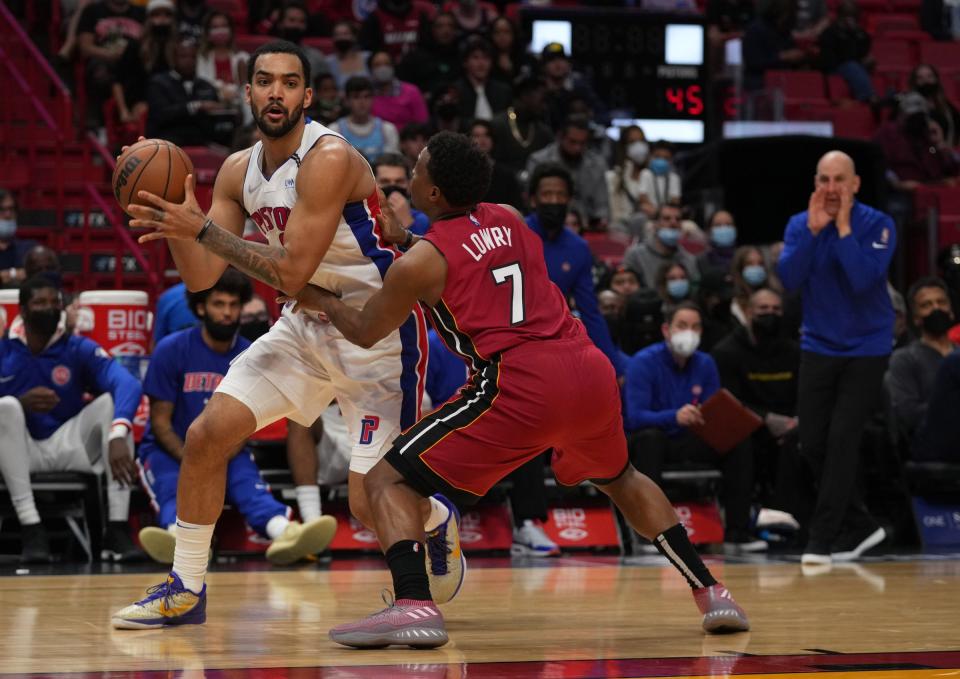Detroit Pistons forward Trey Lyles (8) controls the ball around Miami Heat guard Kyle Lowry (7) during the first half on Thursday, Dec. 23, 2021, at FTX Arena in Miami.
