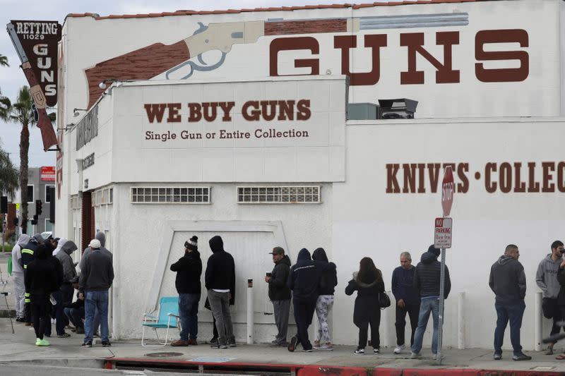 FILE PHOTO: People wait in line outside to buy supplies at the Martin B. Retting, Inc. gun store amid fears of the global growth of coronavirus cases, in Culver City