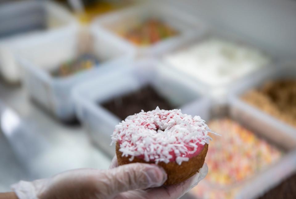 A doughnut, custom-made with strawberry icing and coconut flakes, at Ohana Donuts and Ice Cream, Fishers, Tuesday, July 21, 2020. 