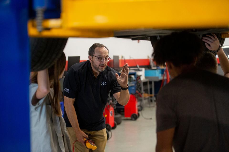 Bob Bolivar, an associate professor at MassBay's Automotive Technology Center in Ashland, speaks to Framingham High School students during the college's boot camp, July 27, 2023.