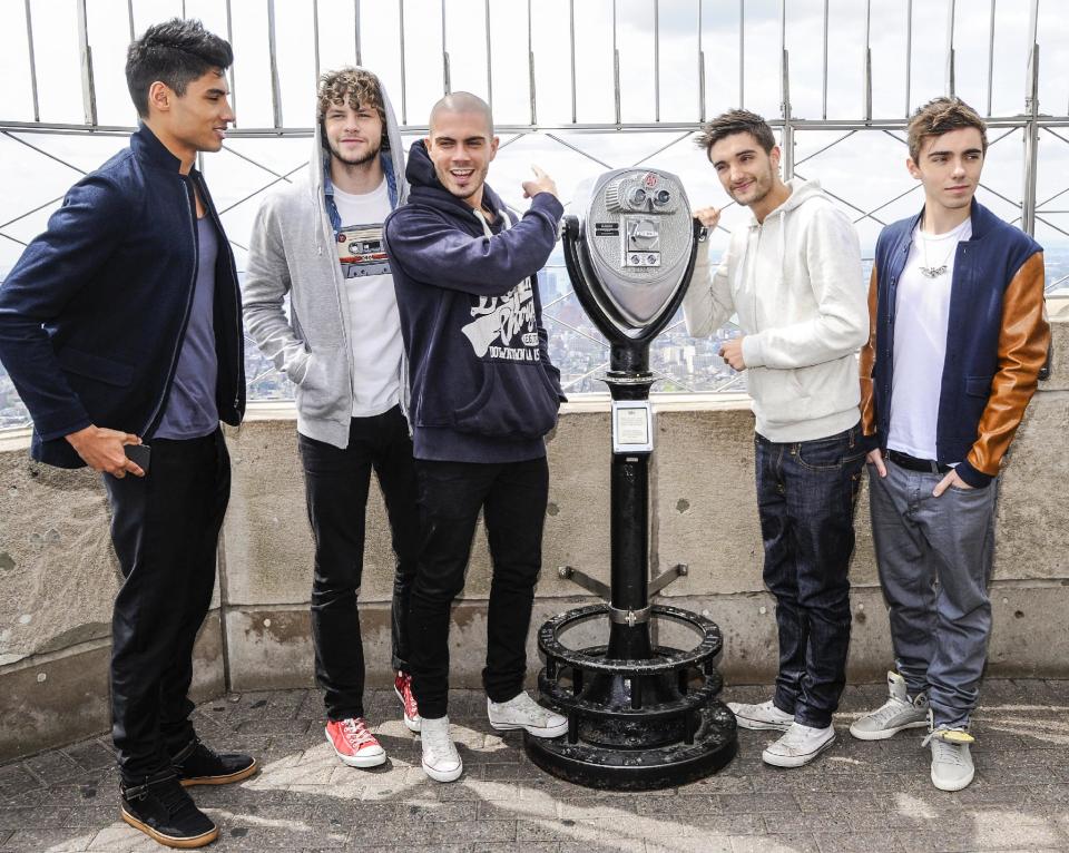 FILE - In this April 24, 2012 file photo, British boy band "The Wanted", from left, Siva Kaneswaran, Jay McGuiness, Max George, Tom Parker and Nathan Sykes visit the Empire State Building in New York. Being a boy band has somewhat haunted the British based-quintet since their formation in 2009: They had to change record labels after being told to learn how to dance. But coming to America _ and achieving some success _ is a dream come true for the group. After releasing two top 5 albums and five hit singles in Europe, they've now duplicated some of that in America with the party jam “Glad You Came,” which has spent eight weeks in the top 10 on Billboard's Hot 100 chart. (AP Photo/Evan Agostini, file)