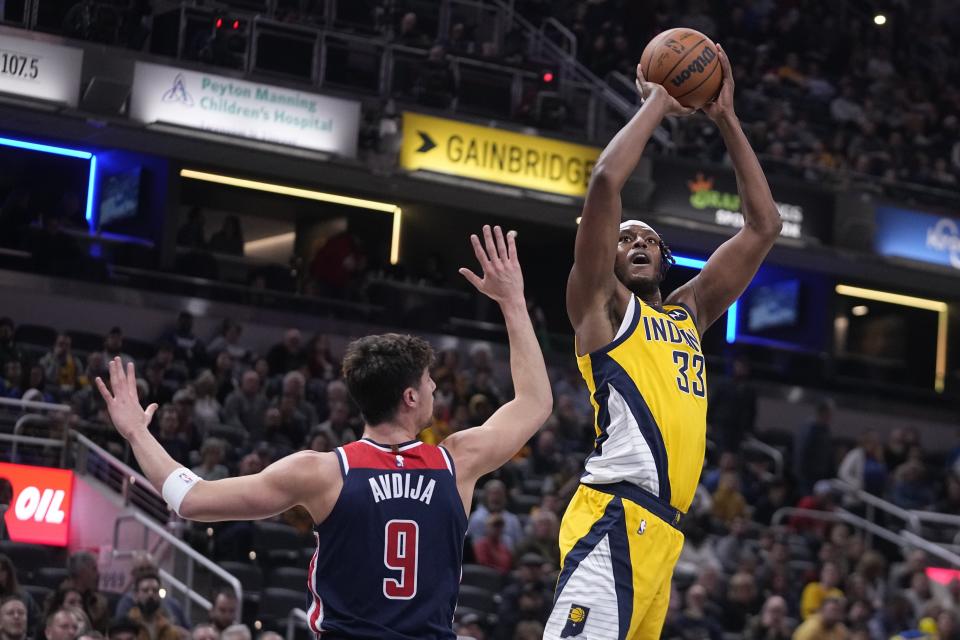 Indiana Pacers center Myles Turner (33) shoots over Washington Wizards forward Deni Avdija (9) during the first half of an NBA basketball game, Friday, Dec. 9, 2022, in Indianapolis. (AP Photo/Darron Cummings)