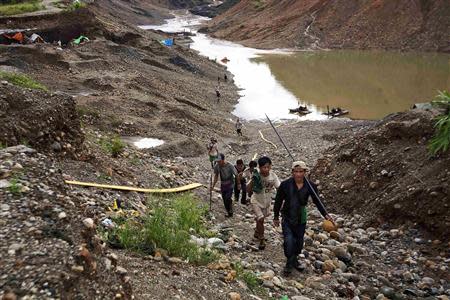 Hand-pickers return from searching for jade through rubble dumped by mining companies at a jade mine in Hpakant township, Kachin State July 7, 2013. REUTERS/Minzayar