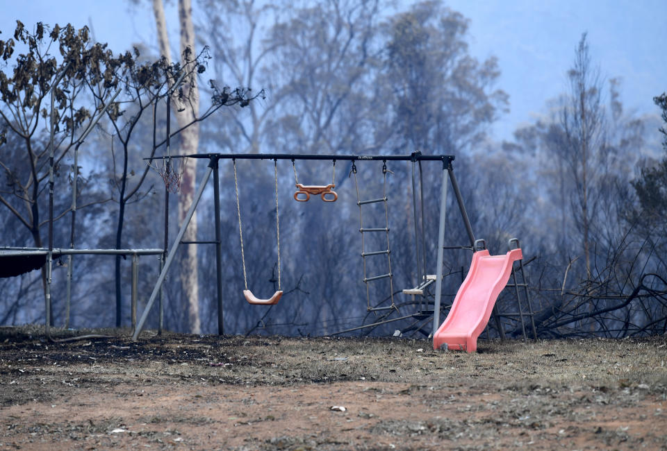 Children's play equipment is seen on a property destroyed by bushfire. 