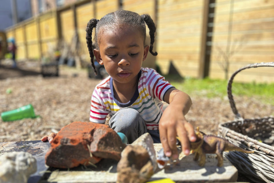 In this undated photo provided by The Hechinger Report, a 3-year-old plays in an outdoor classroom at Early Partners, a child care center in New Orleans that participates in City Seats, a tax-funded program that pays for child care. (Ariel Gilreath/The Hechinger Report via AP)