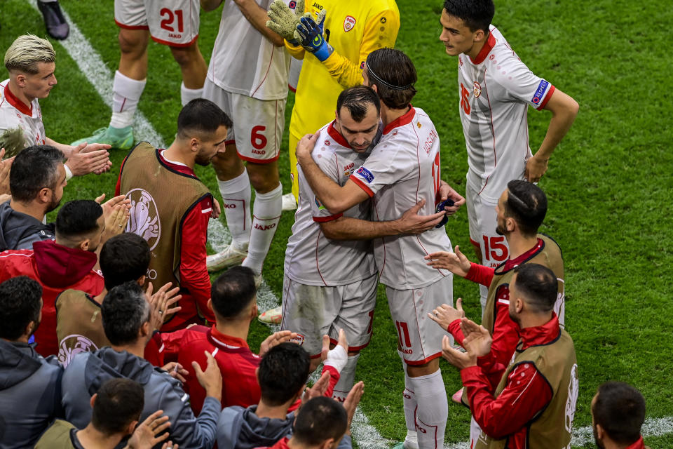 North Macedonia's Goran Pandev leaves the pitch while applauded and embraced by teammates during the Euro 2020 soccer championship group C match between The Netherlands and North Macedonia at the Johan Cruyff ArenA in Amsterdam, Netherlands, Monday, June 21, 2021. (Olaf Kraak, Pool via AP)