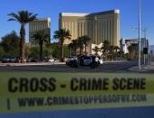 <p>Crime scene tape surrounds the Mandalay Hotel (background) after a gunman killed at least 50 people and wounded more than 200 others when he opened fire on a country music concert in Las Vegas, Nevada on Oct. 2, 2017. (Photo: Mark Ralston/AFP/Getty Images) </p>