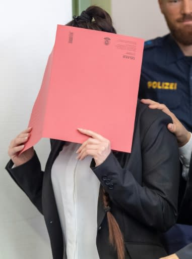 German woman Jennifer W who joined the Islamic State group hides her face as she arrives in court for the opening of her trial on April 9, 2019 in Munich, southern Germany