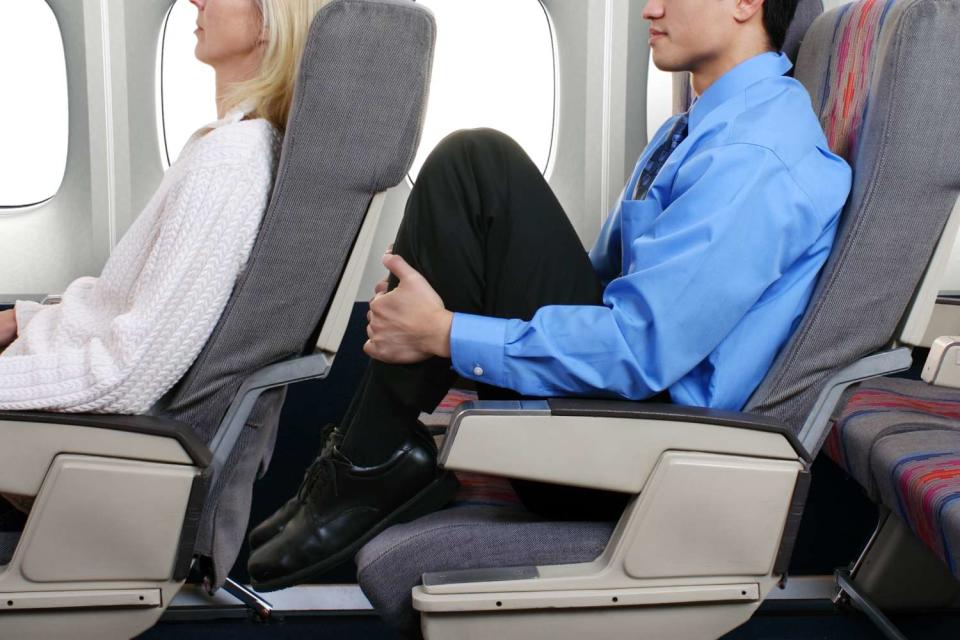 <p>Getty</p> Stock image of a passenger reclining seat on plane 