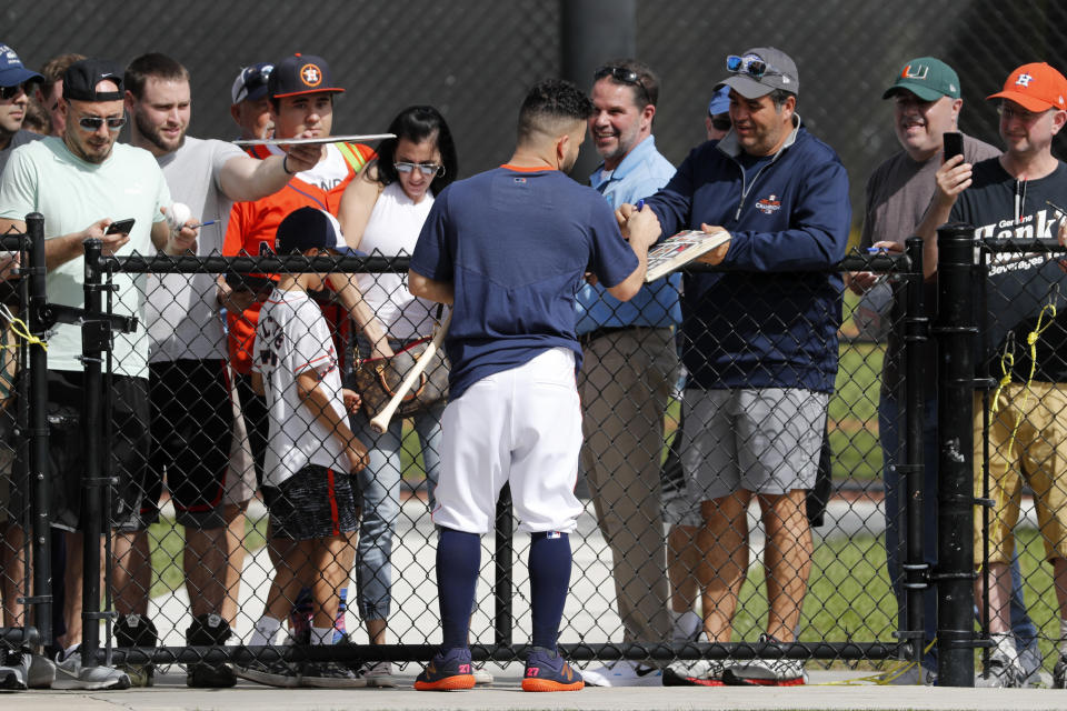 Houston Astros' Jose Altuve signs autographs during spring training baseball practice Thursday, Feb. 13, 2020, in West Palm Beach, Fla. (AP Photo/Jeff Roberson)