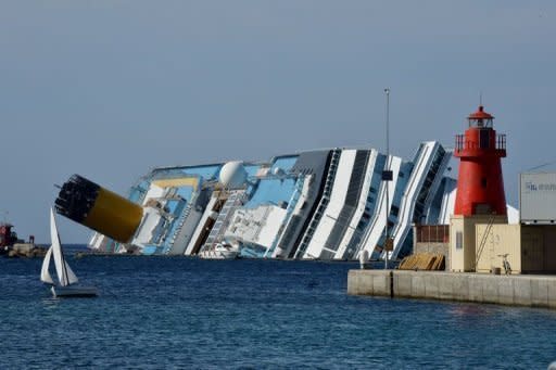 The stranded Costa Concordia cruise ship lies near the harbour of Giglio Porto in June 2012. Europe's top cruise operator has come under pressure at pre-trial hearings into the Costa Concordia disaster as captain Francesco Schettino faced survivors for the first time