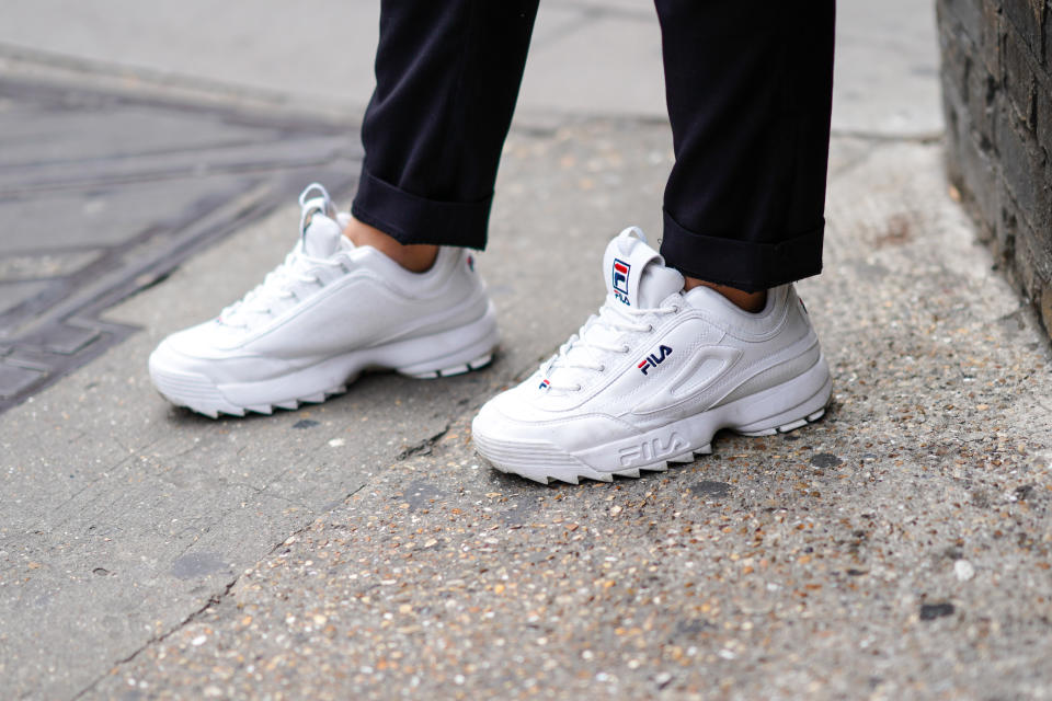 A guest wears white FILA sneakers shoes, during London Fashion Week Men's June 2019 on June 08, 2019 in London, England. (Edward Berthelot/Getty Images)