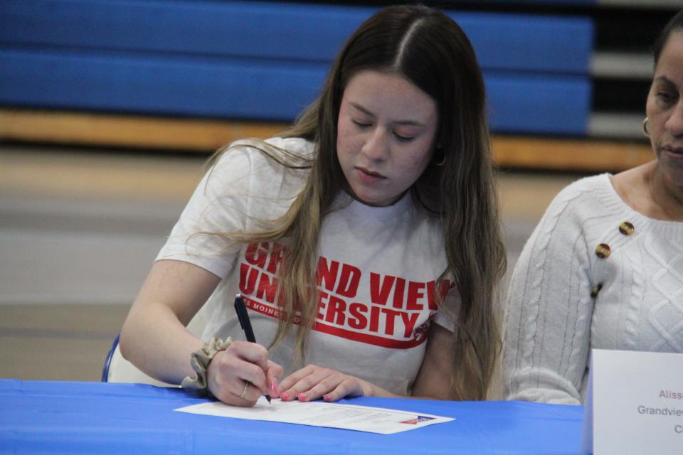 Alisson Diaz signs her National Letter of Intent to cheer at Grand View University during a celebratory signing day on Monday, May 6, 2024, in the Perry High School gym.