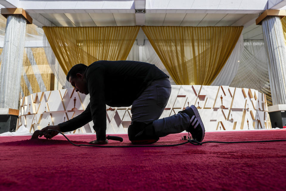 Los Angeles, CA, Wednesday, March 23, 2022 - Pablo Cruz Moreno installs the red carpet as preparations continue for the Academy Awards at Dolby Theater in Hollywood.(Robert Gauthier/Los Angeles Times via Getty Images)