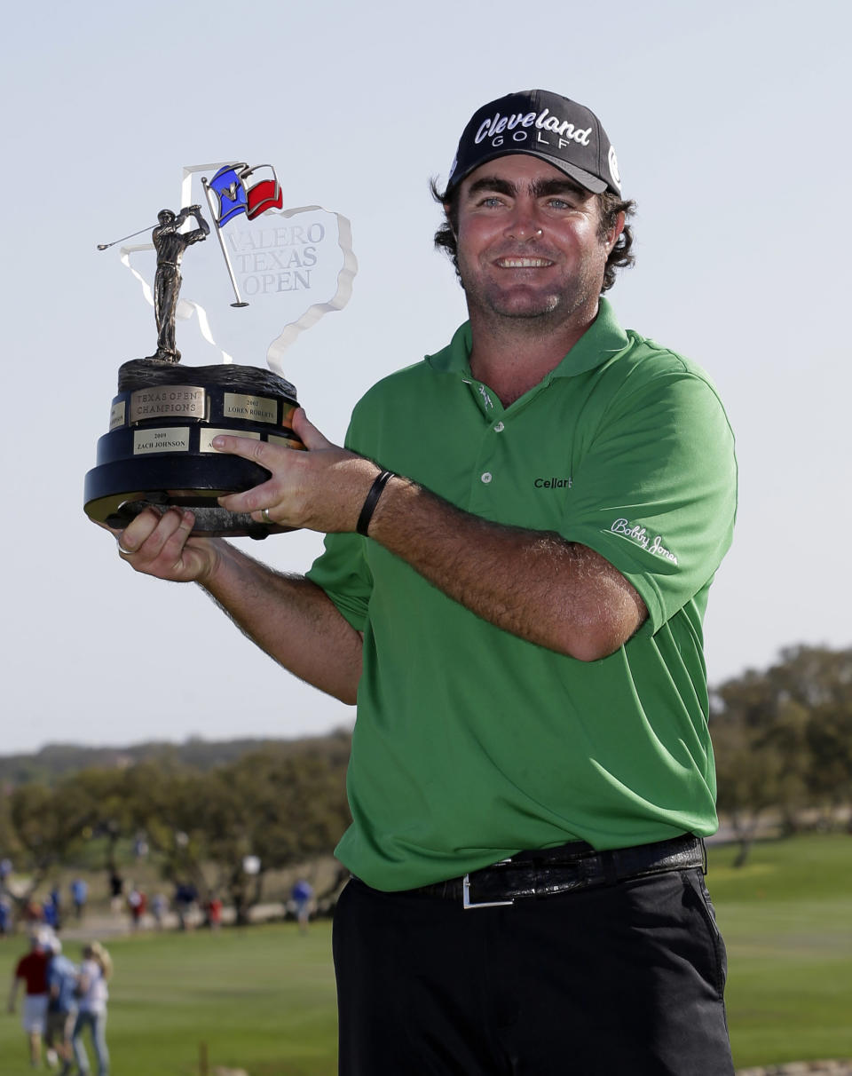 Steven Bowditch, of Australia, poses with his trophy after winning the Texas Open golf tournament, Sunday, March 30, 2014, in San Antonio. (AP Photo/Eric Gay)