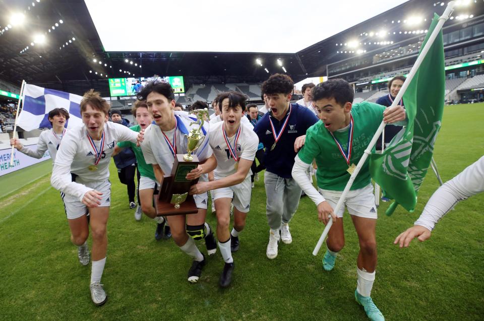 Members of the Grandview Heights boys soccer team run the Division III state championship trophy to their fans following a 4-2 win over Columbiana Crestview at Lower.com Field on Nov. 13.