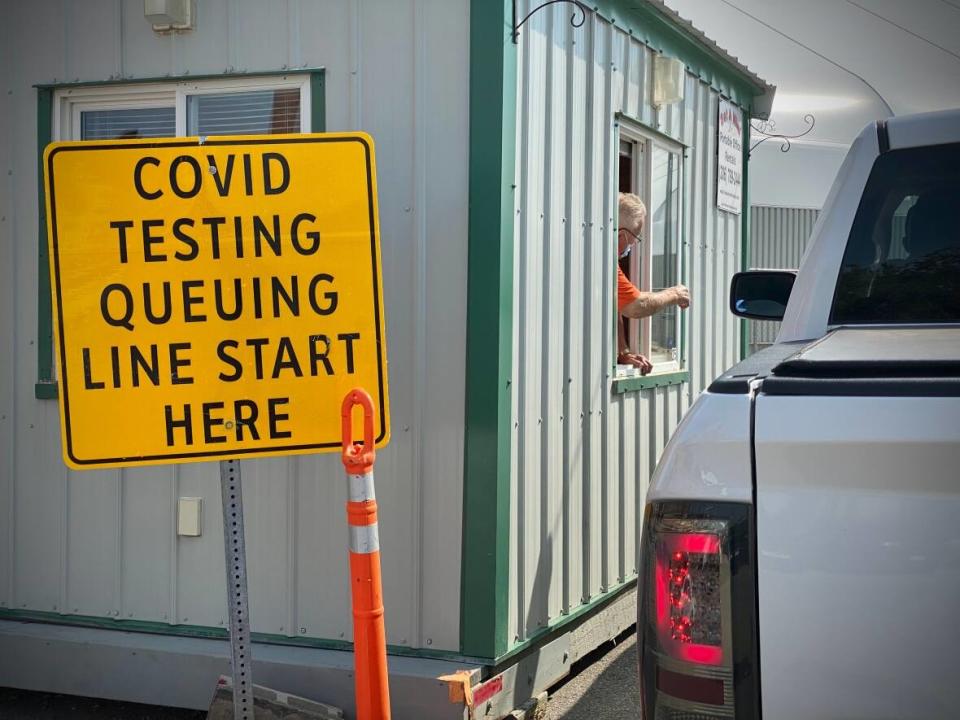 A worker directs a driver to COVID-19 testing at Evraz Place in Regina, Sask., on Sept. 9, 2021.   (Matthew Howard/CBC - image credit)