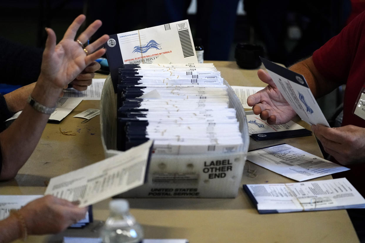 FILE - In this Nov. 4, 2020, file photo, Chester County election workers process mail-in and absentee ballots for the 2020 general election in the United States at West Chester University in West Chester, Pa. Republican efforts to restrict voting access are taking shape in statehouses across the country with a flurry of legislation aimed at limiting measures that led to record turnout in the 2020 presidential election. (AP Photo/Matt Slocum, File)