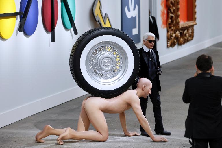 German fashion designer Karl Lagerfeld poses during the Chanel 2014 Spring/Summer ready-to-wear collection fashion show, on October 1, 2013 at the Grand Palais in Paris