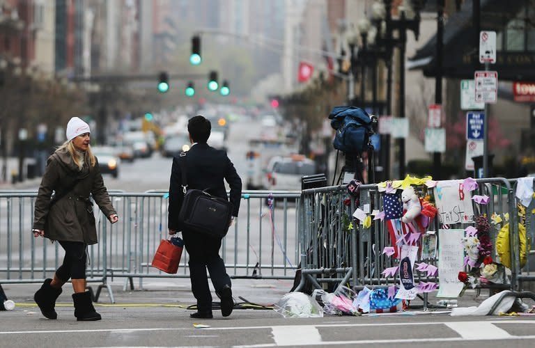 People walk past a makeshift memorial near the site of the Boston Marathon bombings on April 23, 2013. A US delegation including FBI agents interviewed the parents of the Boston marathon bombing suspects in the Russian North Caucasus region of Dagestan, but were told the two brothers had not contacted local Islamist groups, officials said Wednesday