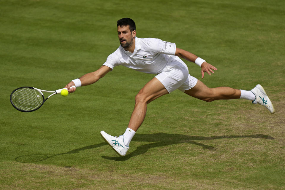 Serbia's Novak Djokovic returns to Spain's Carlos Alcaraz in the men's singles final on Day 14 of the Wimbledon Tennis Championships in London on Sunday 16 July 2023.  (AP Photo/Alastair) Forgive me)