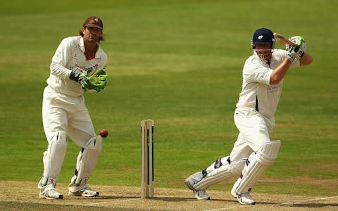 Anthony McGrath of Yorkshire hits the ball towards the boundary, as Luke Sutton of Lancashire looks on - Credit: Matthew Lewis/Getty Images