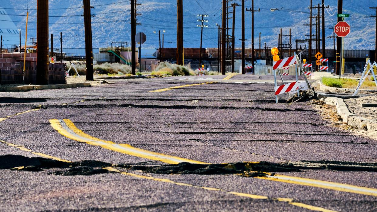  A photo showing a road torn up by an earthquake. 