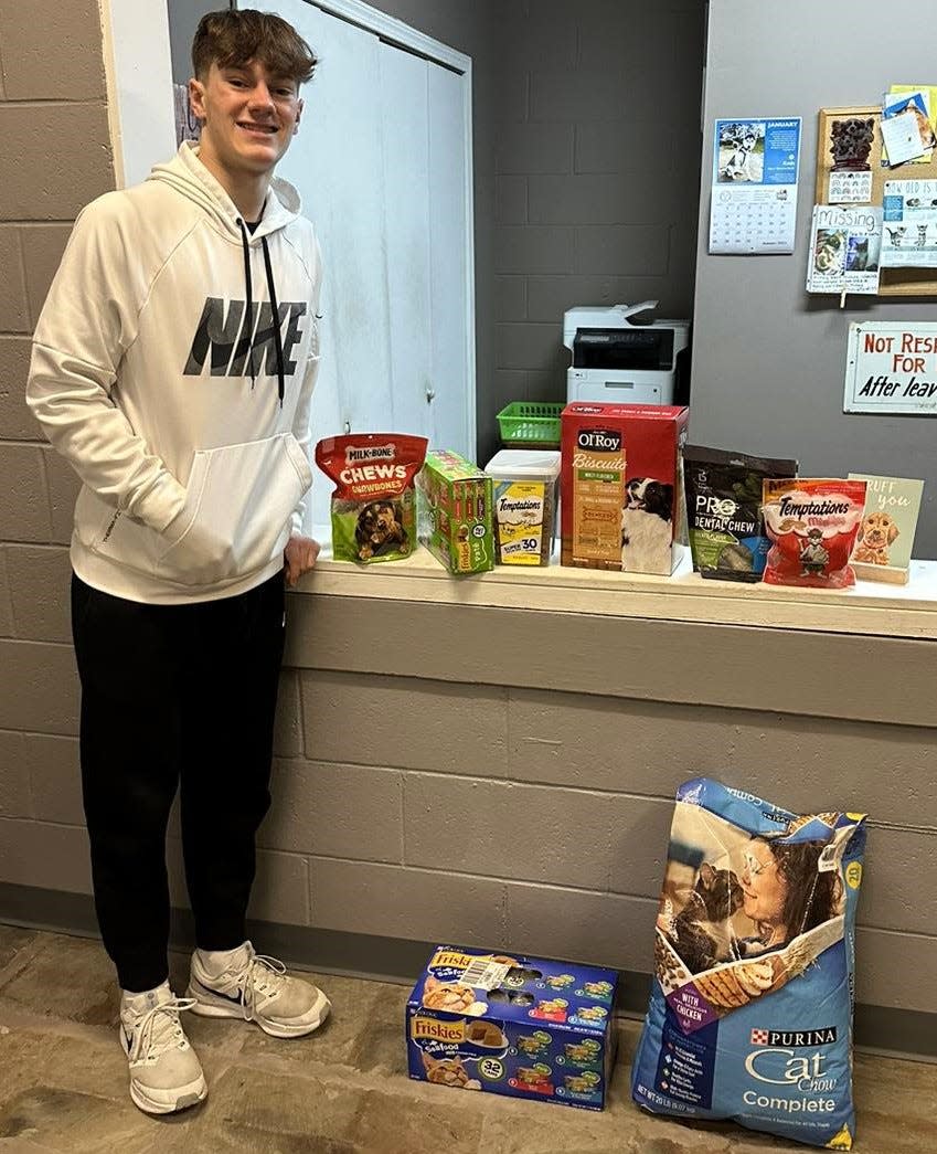 Colton Conkle of Coshocton High School used $100 from the Pay it Forward project of Coshocton County Youth Leadership to buy pet food, cleaning supplies and more for the Coshocton County Animal Shelter. Two other students chose the animal shelter for their cause as well.