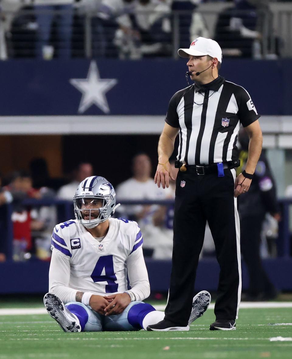 Dallas Cowboys quarterback Dak Prescott sits on the turf after a second-half play against the San Francisco 49ers.