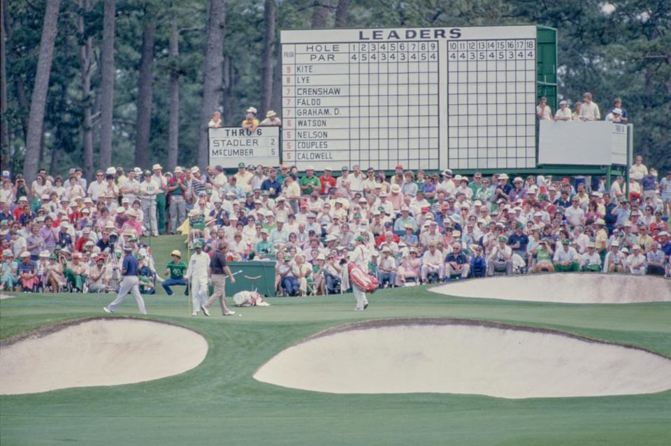 Craig Stadler, Mark McCumber and caddies on green at the Augusta National Golf Course during the 1984 Masters.