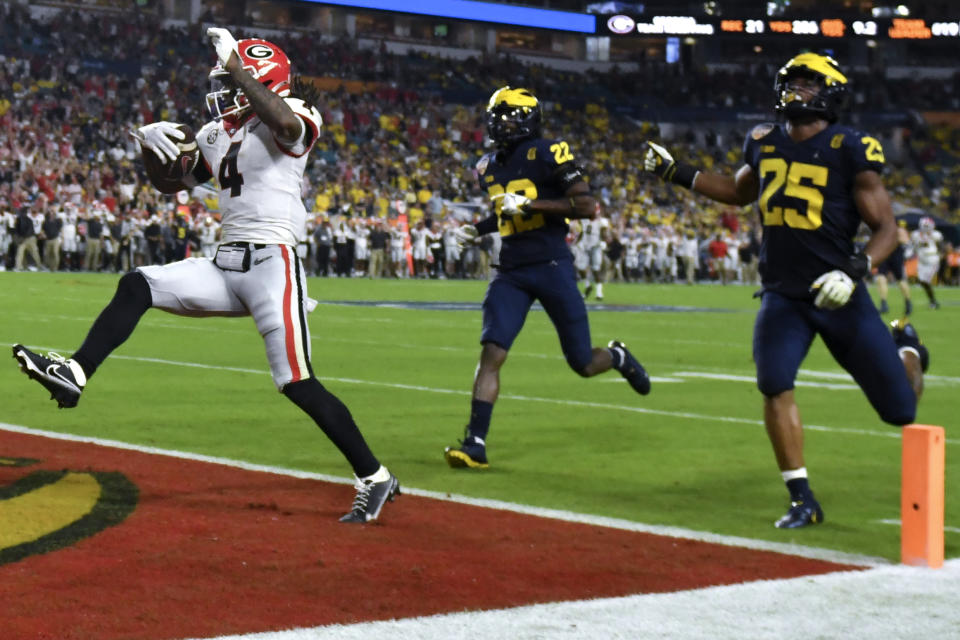 Georgia running back James Cook celebrates after scoring during the second half of the Orange Bowl NCAA College Football Playoff semifinal game against Michigan, Friday, Dec. 31, 2021, in Miami Gardens, Fla. (AP Photo/Jim Rassol)