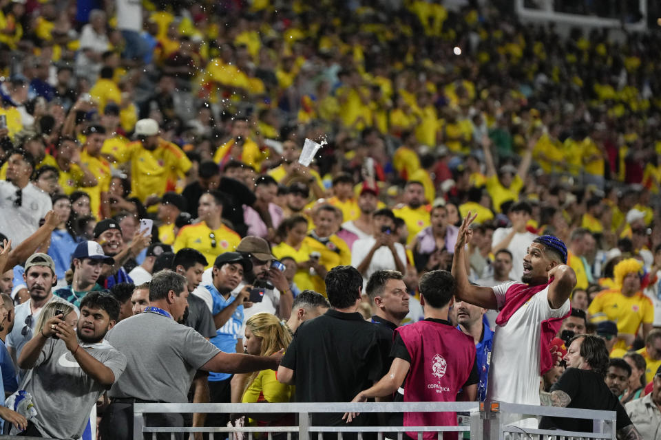 Uruguay's Ronald Araujo, right, argues with fans after a Copa America semifinal soccer match against Colombia in Charlotte, N.C., Wednesday, July 10, 2024. (AP Photo/Julia Nikhinson)